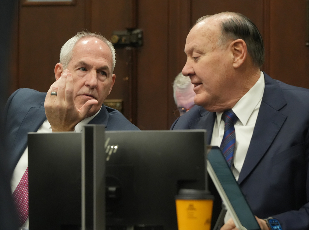 Ex-FirstEnergy Senior Vice President Michael Dowling and former FirstEnergy CEO Chuck Jones talk as they wait for their trial to resume in Summit County Common Pleas Judge Susan Baker Ross's courtroom in Akron, Ohio on Wednesday, March 11, 2026. (Mike Cardew /Akron Beacon Journal via AP, Pool)