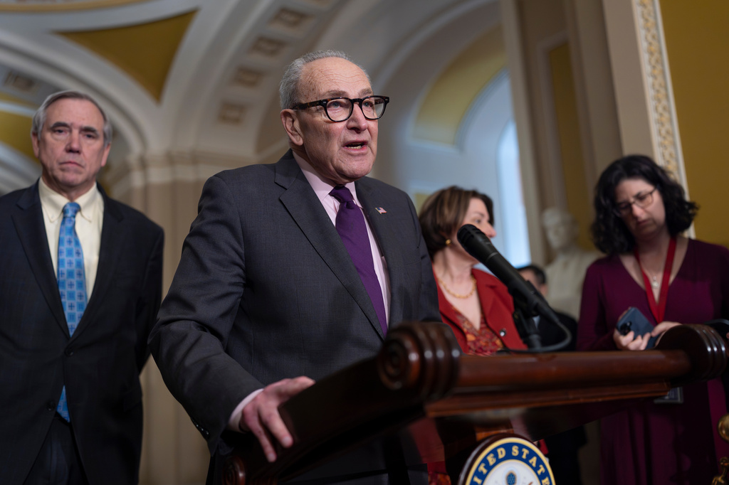 Senate Minority Leader Chuck Schumer, D-N.Y., joined at left by Sen. Jeff Merkley, D-Ore., speaks to reporters following a closed-door party meeting, at the Capitol in Washington, Tuesday, April 21, 2026. (AP Photo/J. Scott Applewhite)