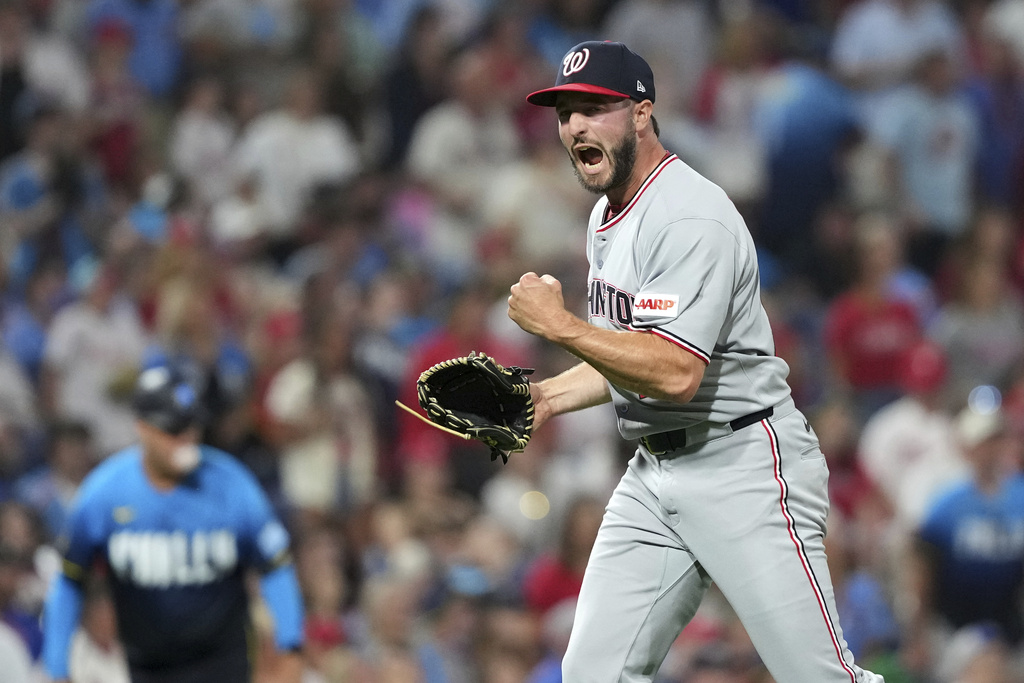 Washington Nationals pitcher PJ Poulin reacts after the Nationals won a baseball game against the Philadelphia Phillies Friday, Aug. 22, 2025, in Philadelphia. (AP Photo/Matt Slocum)