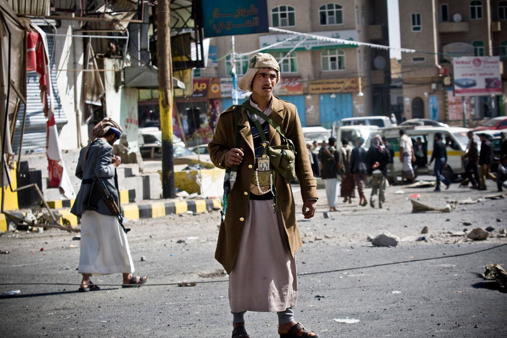 FILE - Houthi Shiite Yemenis gather while guarding a street leading to the presidential palace in Sanaa, Yemen on Jan. 20, 2015. (AP Photo/Hani Mohammed, File)