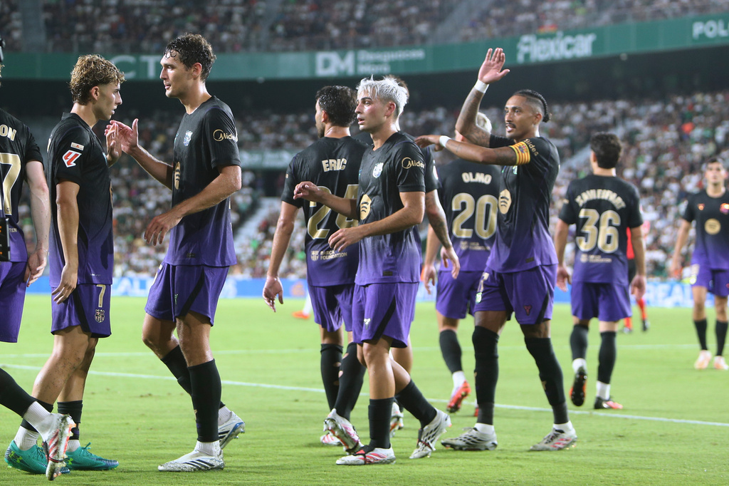 Barcelona's Fermin Lopez, left, celebrates after scoring his side's his fifth goal during a Spanish La Liga soccer match between Elche and Barcelona in Elche, Spain, Sunday, Aug. 23, 2026. (AP Photo/Alberto Saiz)