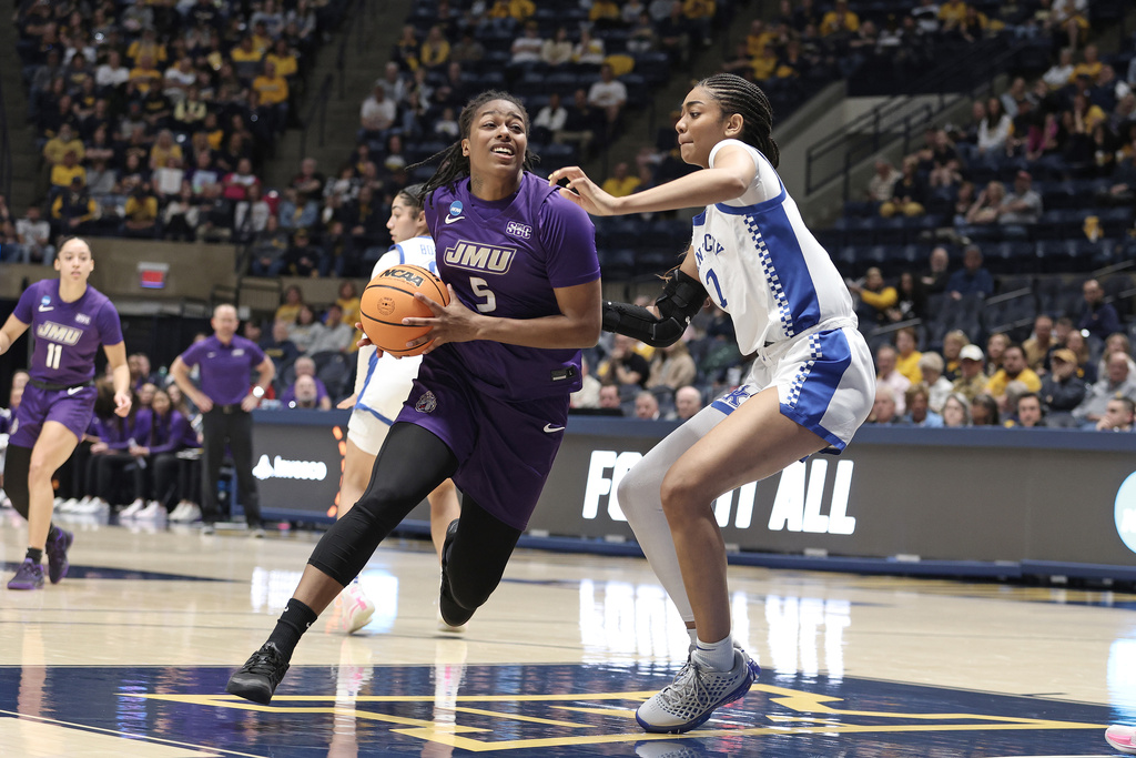 James Madison forward Ashanti Barnes (5) is defended by Kentucky forward Teonni Key (7) during the first half in the first round of the NCAA college basketball tournament, Saturday, March 21, 2026, in Morgantown, W.Va. (AP Photo/Kathleen Batten)