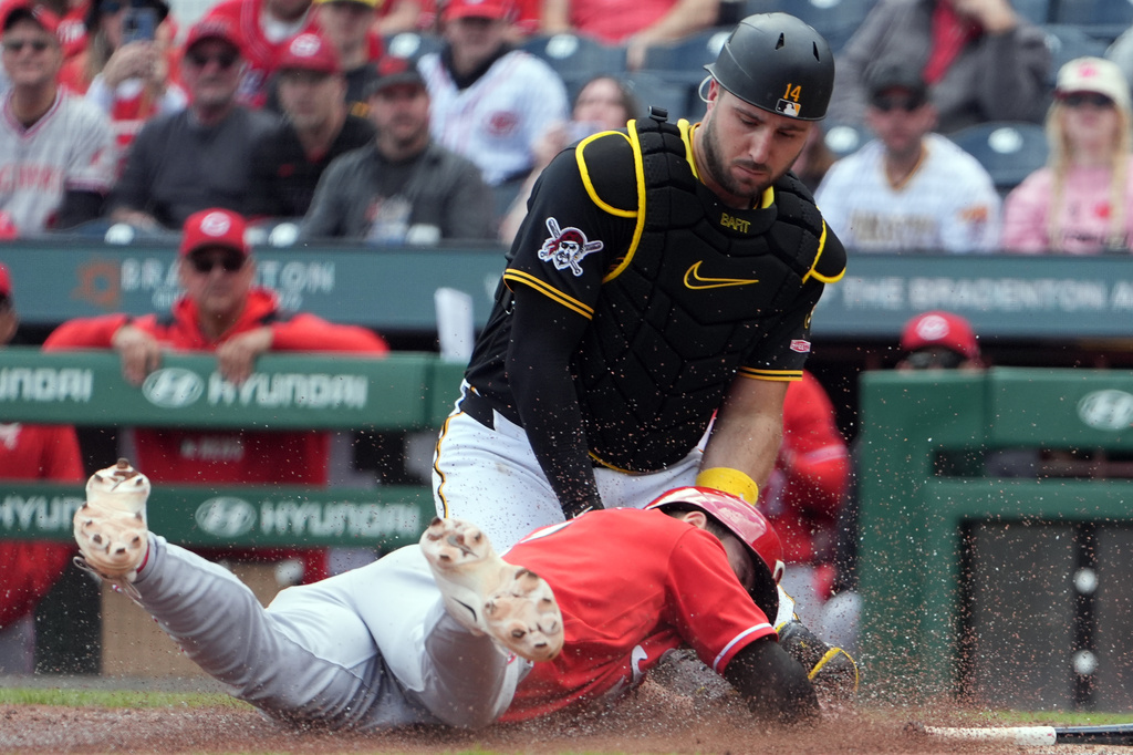 Pittsburgh Pirates catcher Joey Bart, top, tags out Cincinnati Reds' Spencer Steer, bottom, who was attempting to score on a ball hit by Reds' Matt McLain in the eighth inning of a baseball game in Pittsburgh, Sunday, May 3, 2026. (AP Photo/Tom E. Puskar)