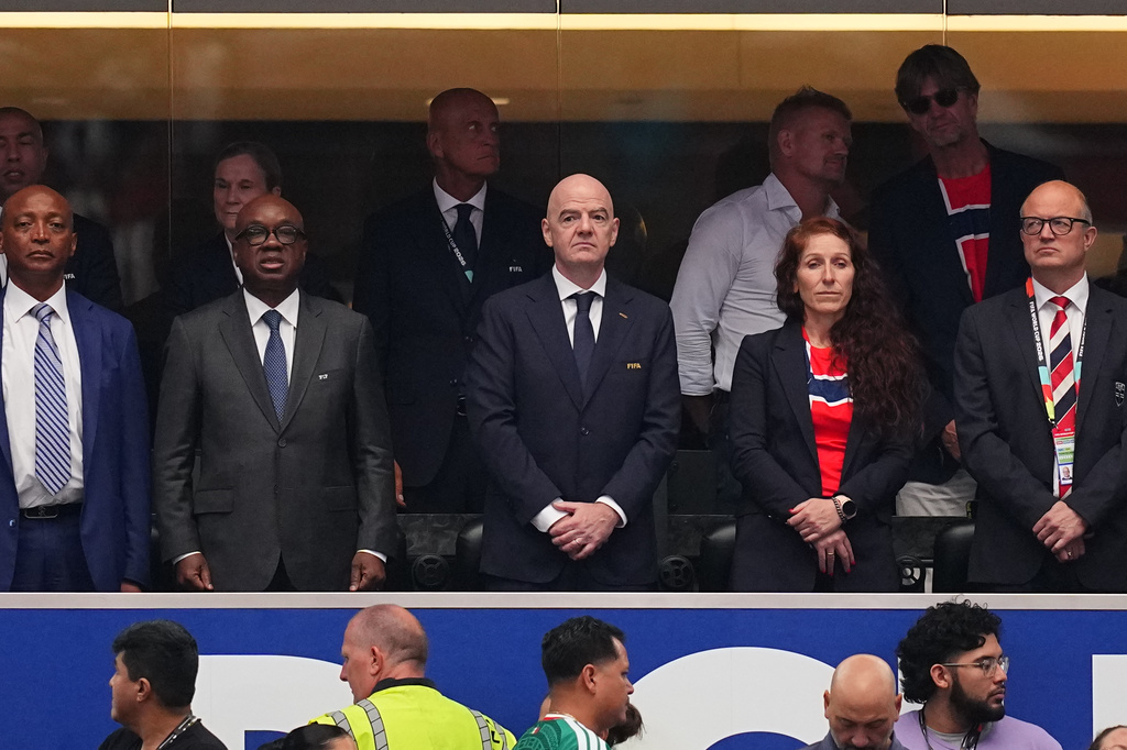 FIFA President Gianni Infantino, front center, and Norway's Football Federation president Lise Klavenessin, front second right, the stands ahead of the World Cup round of 32 soccer match between Ivory Coast and Norway in Arlington, Texas, near Dallas, Tuesday, June 30, 2026. (AP Photo/Julio Cortez)