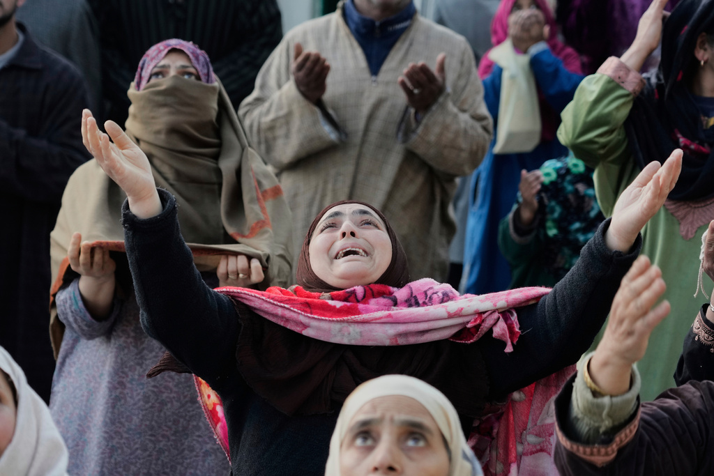 FILE - Muslim devotees pray as the head priest displays a holy relic believed to be a hair from the beard of the Prophet Muhammad during special prayers at Hazratbal shrine in Srinagar, Indian controlled Kashmir, SMarch 22, 2025 (AP Photo/Mukhtar Khan)