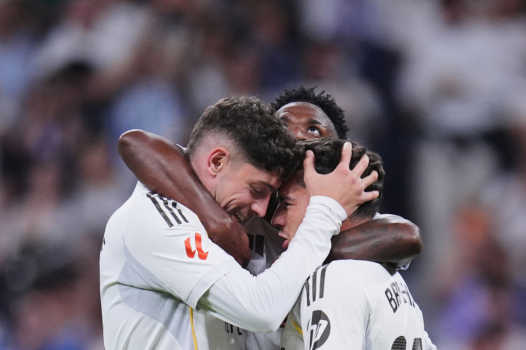 Real Madrid's Federico Valverde, left celebrates with his teammates after scoring the opening goal during a Spanish La Liga soccer match between Real Madrid and Girona in Madrid, Spain, Friday, April 10, 2026. (AP Photo/Manu Fernandez)