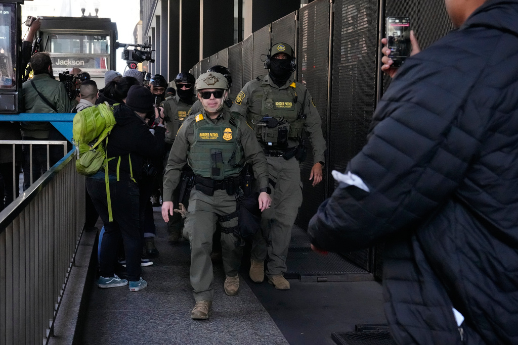 U.S. Customs and Border Patrol agents arrive to escort U.S. Customs and Border Patrol Gregory Bovino from federal court in Chicago, Tuesday, Oct. 28, 2025. (AP Photo/Nam Y. Huh)