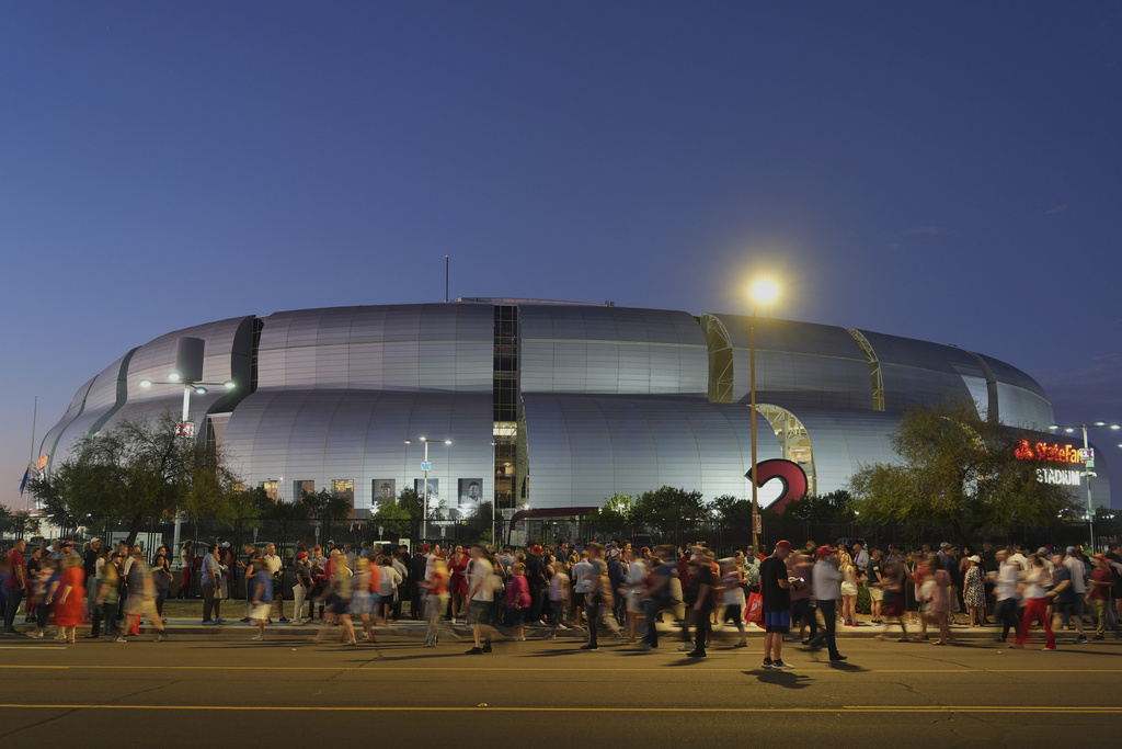 People wait in line before a memorial for conservative activist Charlie Kirk Sunday, Sept. 21, 2025, at State Farm Stadium in Glendale, Ariz. (AP Photo/Jae C. Hong)