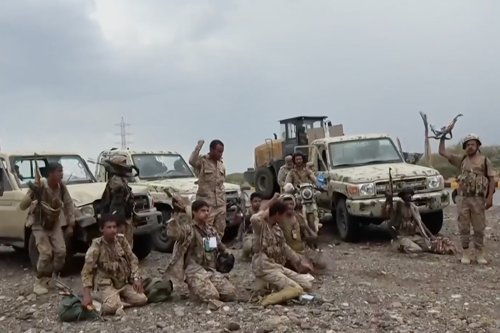 This image taken from undated video released by the Ansar Allah Media Office, the media arm of Yemen's Houthi rebels, on Saturday, Sept. 12, 2026, shows Houthi fighters chant after praying beside military vehicles during what the group says was their advance against Saudi-backed forces at an undisclosed location in southern Yemen. (Ansar Allah Media Office via AP)