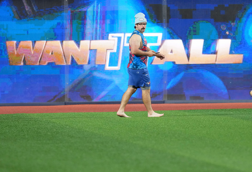 Toronto Blue Jays outfielder Davis Schneider walks barefooted in the outfield during World Series baseball workouts, Thursday, Oct. 30, 2025, in Toronto. (Nathan Denette/The Canadian Press via AP) Toronto Blue Jays outfielder Davis Schneider walks barefooted in the outfield during World Series baseball workouts, Thursday, Oct. 30, 2025, in Toronto. (Nathan Denette/The Canadian Press via AP)