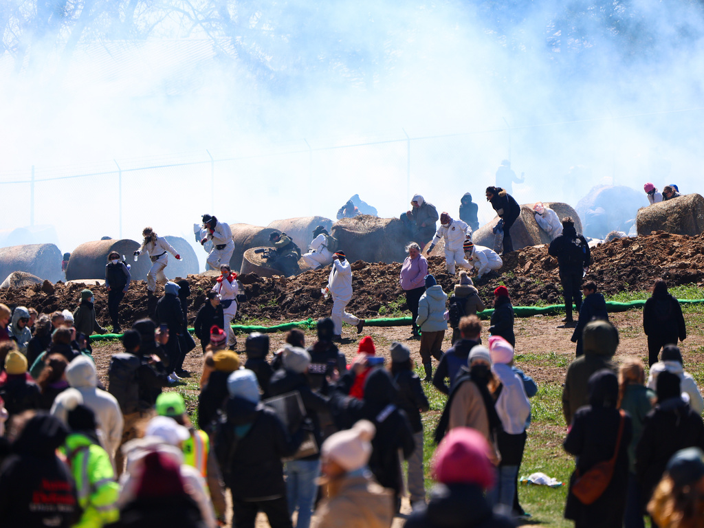 Law enforcement deploy tear gas as activists attempt to gain entry into Ridglan Farms beagle breeding and research facility on Saturday, April 18, 2026, in Blue Mounds, Wis. (Owen Ziliak/Wisconsin State Journal via AP)