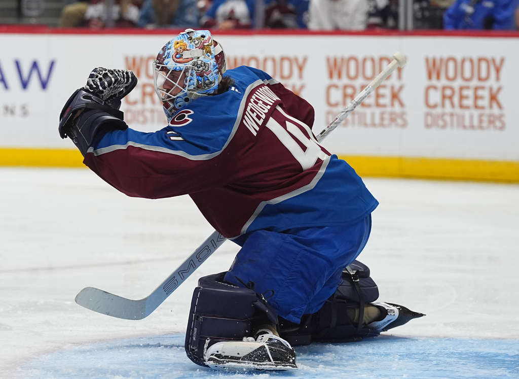 Colorado Avalanche goaltender Scott Wedgewood makes a glove-save in the second period of an NHL hockey game against the Boston Bruins, Saturday, Oct. 18, 2025, in Denver. (AP Photo/David Zalubowski)