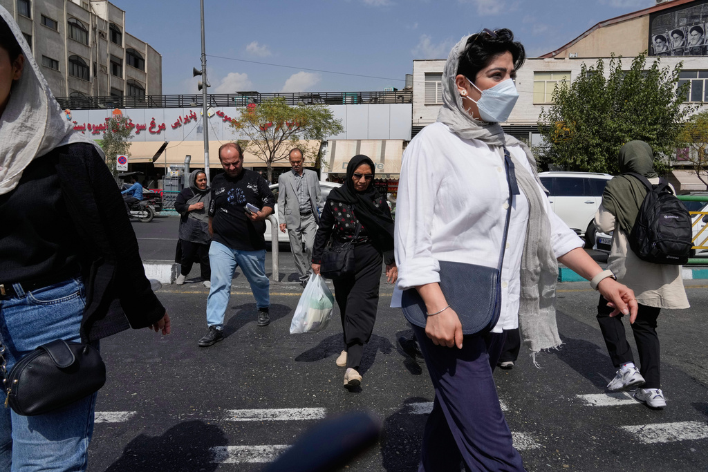 FILE - People cross the Enqelab-e-Eslami (Islamic Revolution) street in Tehran, Iran, on Sept. 27, 2025. (AP Photo/Vahid Salemi, File)