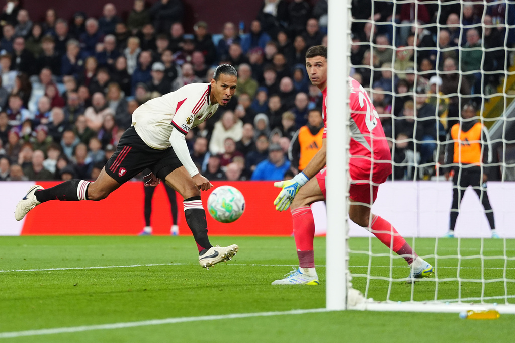 Liverpool's Virgil van Dijk, left, scores a goal during the English Premier League soccer match between Aston Villa and Liverpool in Birmingham, England, Friday, May 15, 2026. (David Davies/PA via AP)
