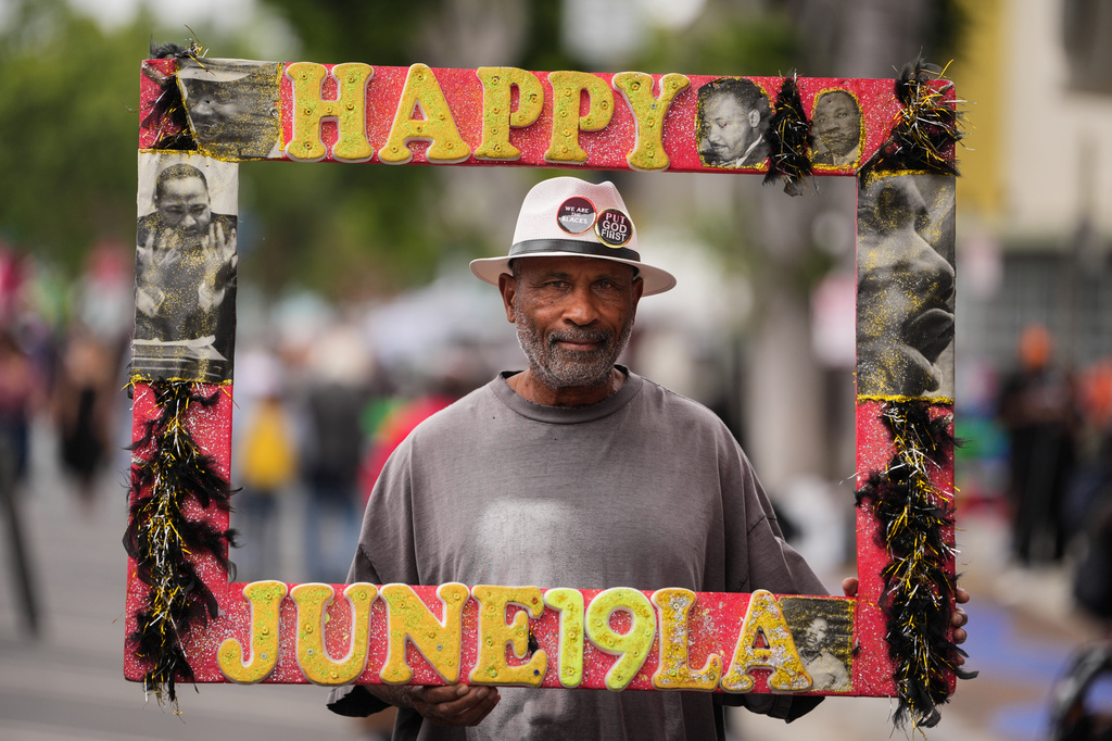 A person, who declined to give his name, stands for a photo during a Juneteenth celebration in the Leimert Park neighborhood of Los Angeles, Friday, June 19, 2026. (AP Photo/Jae C. Hong)