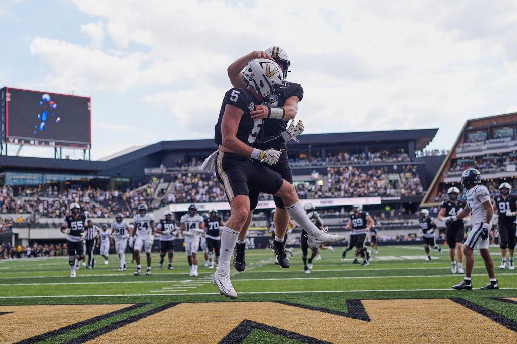 Vanderbilt wide receiver Richie Hoskins (5) celebrates his touchdown with quarterback Diego Pavia, behind, during the second half of an NCAA college football game against Utah State, Saturday, Sept. 27, 2025, in Nashville, Tenn. (AP Photo/George Walker IV)