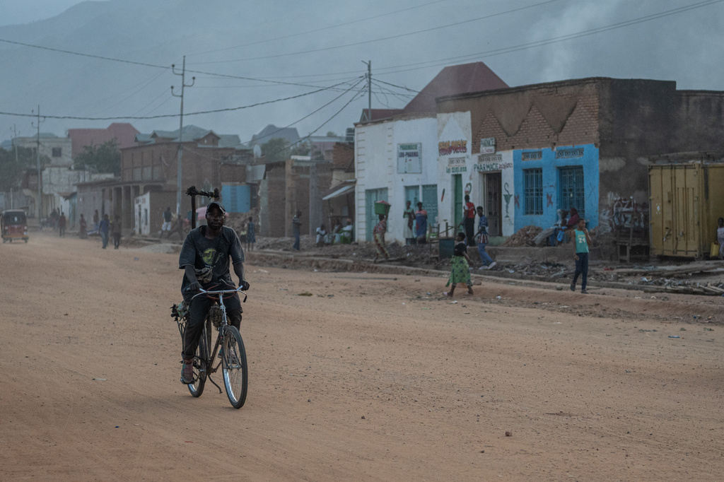 A man rides a bicycle along a street as people return to homes in Uvira Democratic Republic of Congo, Saturday, Dec. 13, 2025. (AP Photo/Moses Sawasawa)