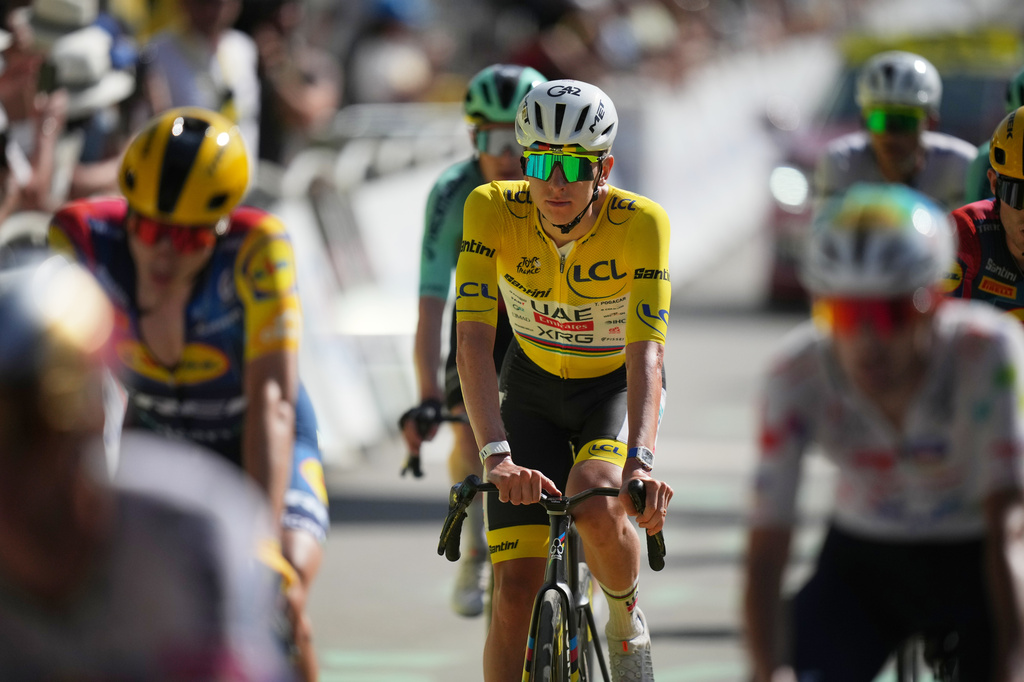 Slovenia's Tadej Pogacar, wearing the overall leader's yellow jersey crosses the finish line of the eighteenth stage of the Tour de France cycling race, with start in Voiron and finish in Orcieres-Merlette, France, Thursday, July 23, 2026. (AP Photo/Mosa'ab Elshamy)