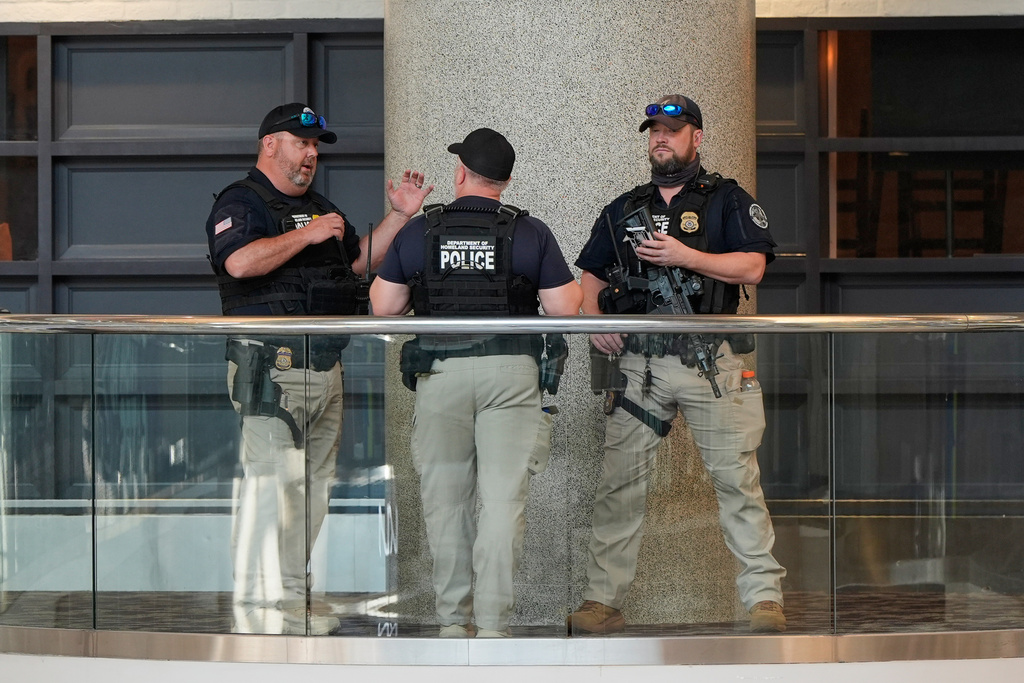Federal immigration agents are seen at the Hartsfield-Jackson Atlanta International Airport, Monday, March 23, 2026, in Atlanta. (AP Photo/Mike Stewart)