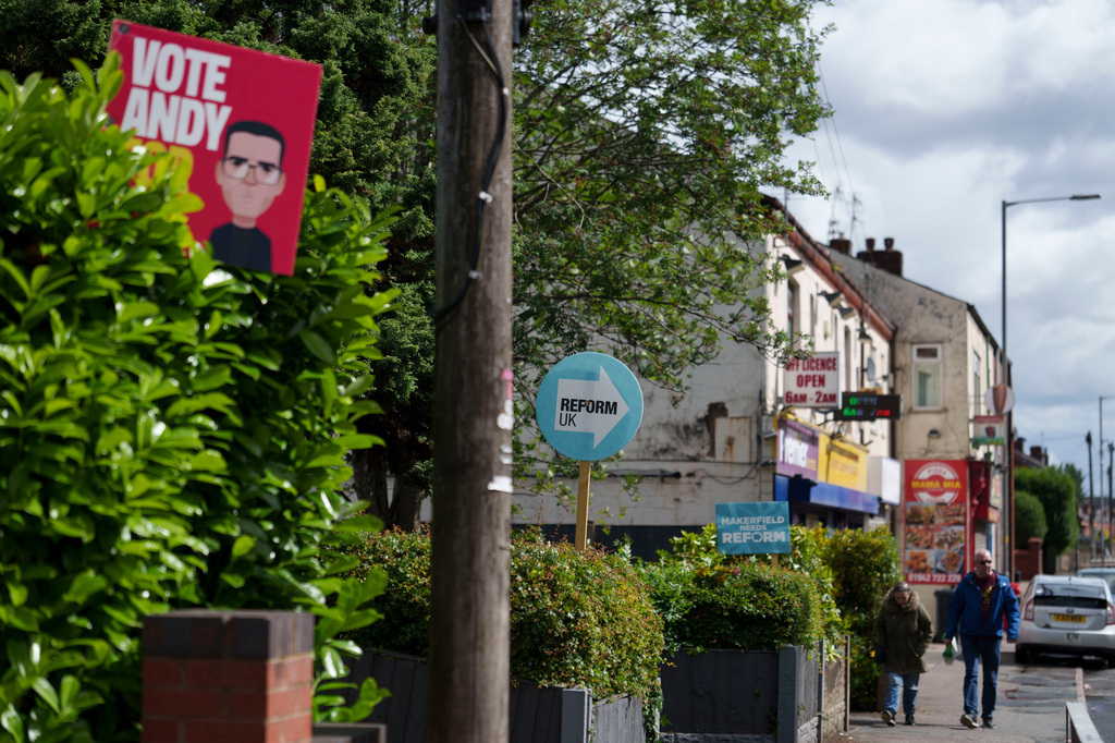 Campaign posters for Andy Burnham and the Reform UK party are displayed in the town of Ashton-in-Makerfield before the forthcoming Makerfield by-election, in Greater Manchester, England, Tuesday, June 9, 2026. (AP Photo/Jon Super)
