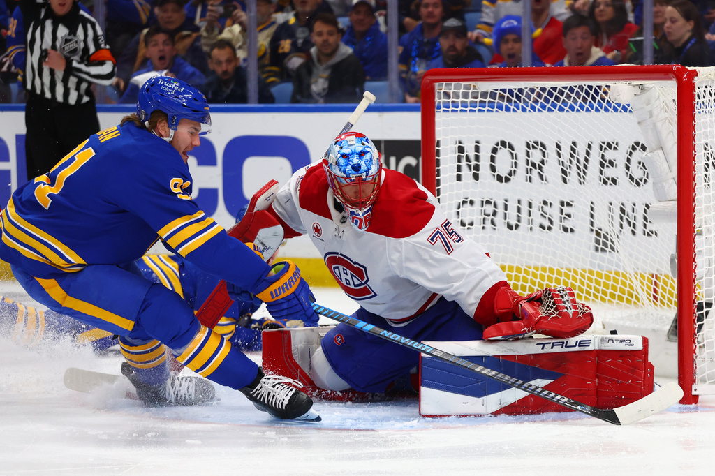 Buffalo Sabres right wing Josh Doan, left, is stopped by Montréal Canadiens goaltender Jakub Dobes (75) during the first period in Game 1 of a second-round NHL hockey Stanley Cup playoff series, Wednesday, May 6, 2026, in Buffalo, N.Y. (AP Photo/Jeffrey T. Barnes)