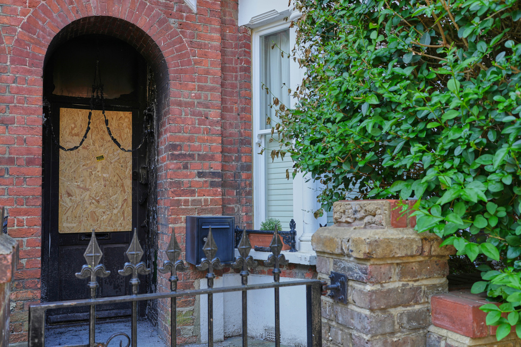 FILE - Fire damage in the doorway of a house belonging to British Prime Minister Keir Starmer in Kentish Town in London, May 13, 2025. (AP Photo/Kirsty Wigglesworth, File)