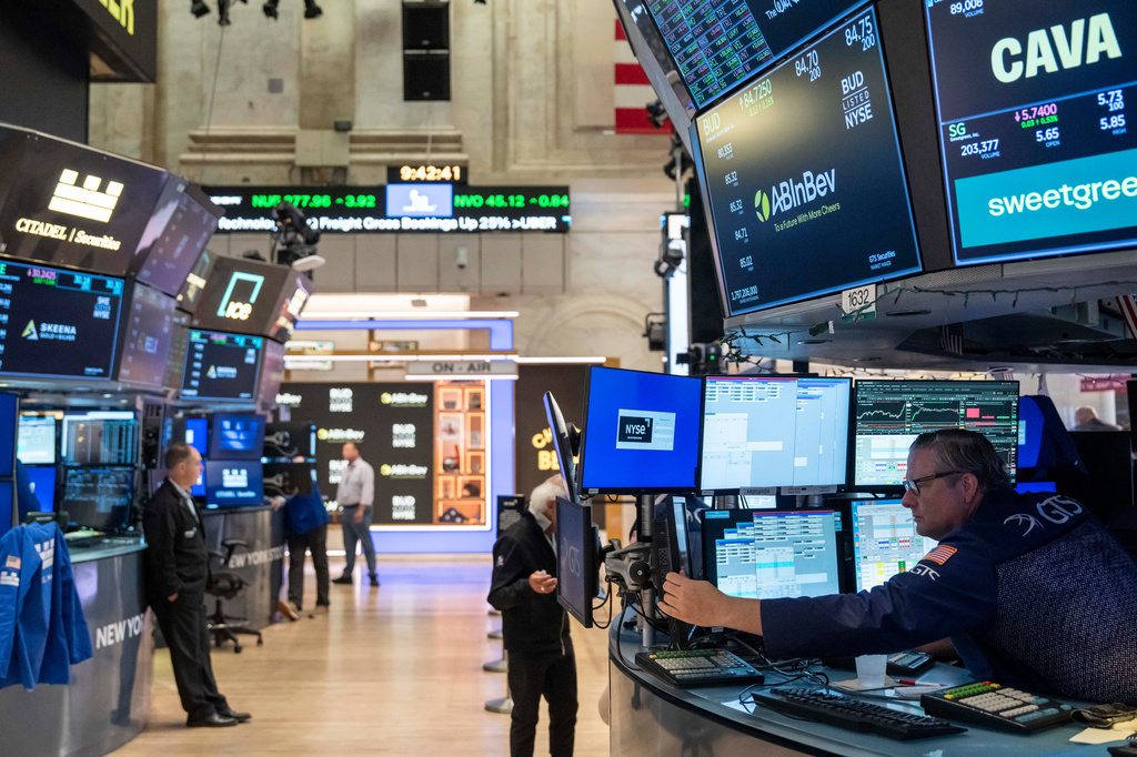 Specialist Gregg Maloney, bottom right, works on the floor of the New York Stock Exchange, Wednesday, Aug. 5, 2026, in New York. (AP Photo/Yuki Iwamura)