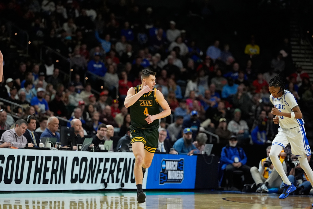 Siena guard Gavin Doty (4) celebrates after scoring during the first half in the first round of the NCAA college basketball tournament against Duke, Thursday, March 19, 2026, in Greenville, S.C. (AP Photo/Brynn Anderson)