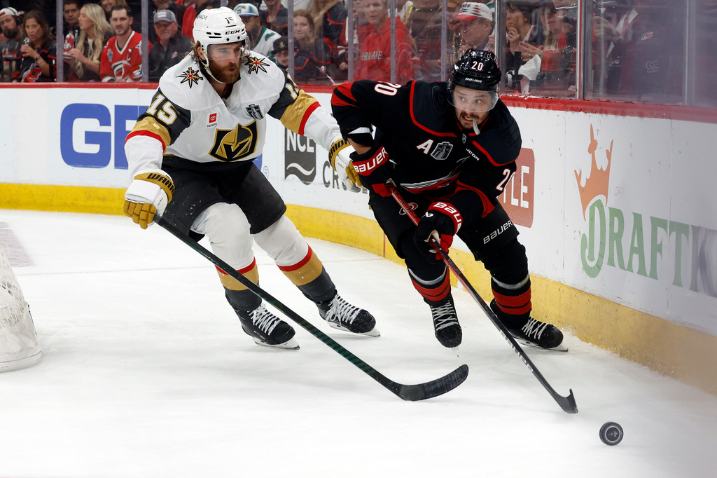 Carolina Hurricanes' Sebastian Aho (20) moves the puck in front of Vegas Golden Knights' Noah Hanifin (15) during the second period in Game 5 of the NHL hockey Stanley Cup Final series in Raleigh, N.C., Thursday, June 11, 2026. (AP Photo/Karl DeBlaker)