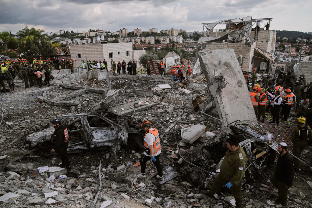 Rescue workers and military personnel operate at the scene where several people were killed in an Iranian missile strike in Beit Shemesh, Israel Sunday, March 1, 2026. (AP Photo/Leo Correa)