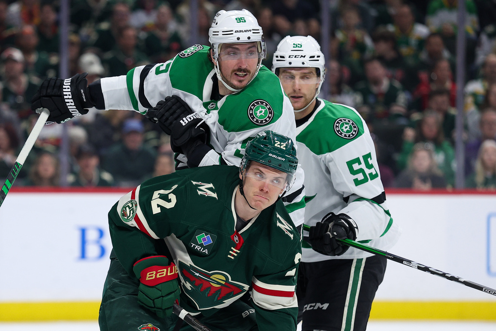 Minnesota Wild right wing Danila Yurov (22) and Dallas Stars center Matt Duchene (95) compete for the puck during the first period of an NHL hockey game Saturday, March 21, 2026, in St. Paul, Minn. (AP Photo/Matt Krohn)