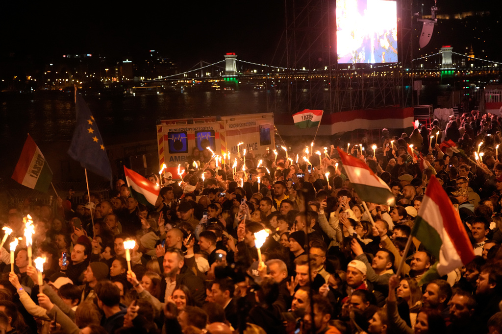 Supporters of Peter Magyar, the leader of the opposition Tisza party celebrate after a parliamentary election in Budapest, Hungary, Sunday, April 12, 2026. (AP Photo/Darko Bandic)