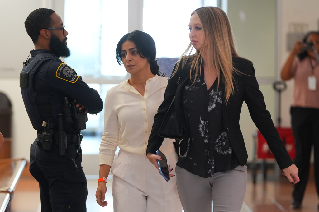 Nausheen Gilkar, center, walks in a hallway at family court in Dallas, Tuesday, Aug. 25, 2026. (AP Photo/LM Otero)