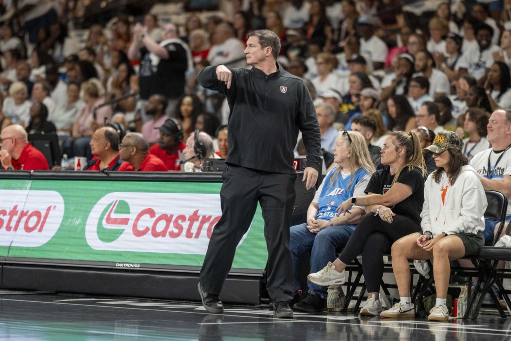Atlanta Dream head coach Karl Smesko, center, reacts to a call during the first half of Game 1 against the Indiana Fever in the first round of the WNBA basketball playoffs Sunday, Sept. 14, 2025, in Atlanta. (AP Photo/Erik Rank)
