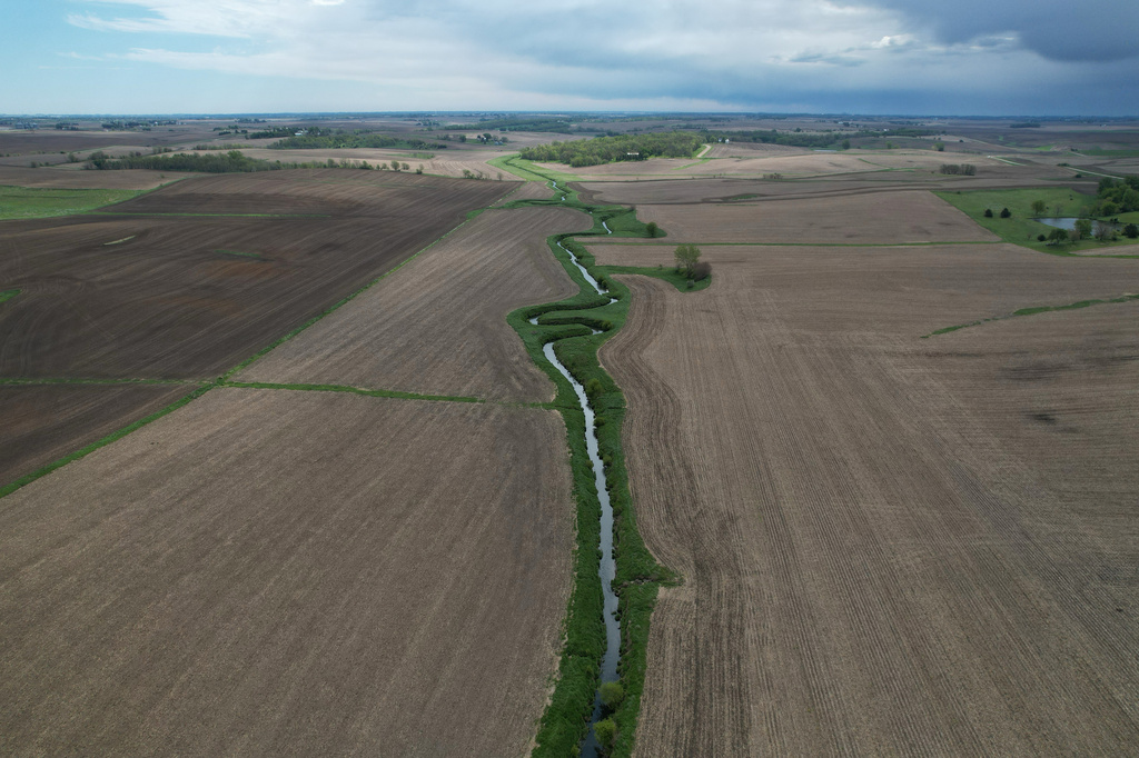 A stream cuts through a farm field Thursday, May 7, 2026, near Marshalltown, Iowa. (AP Photo/Brittany Peterson)