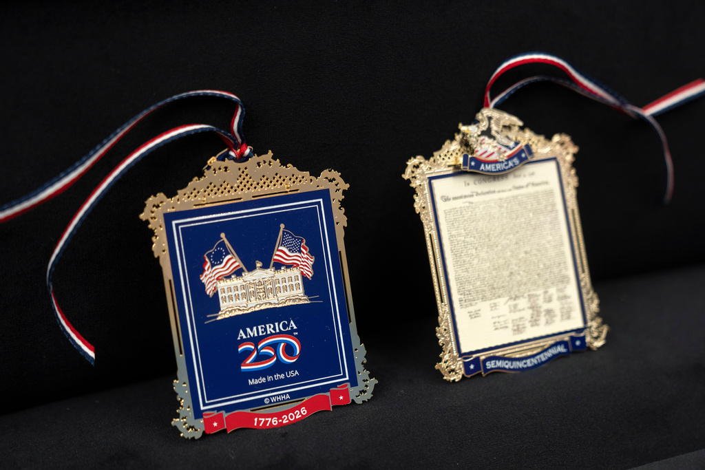 The front and back of a commemorative ornament released by America250 as part of events leading up to the 250th anniversary of the signing of the Declaration of Independence in 1776, is photographed Thursday, Nov. 13, 2025, in Washington. (AP Photo/Mark Schiefelbein)