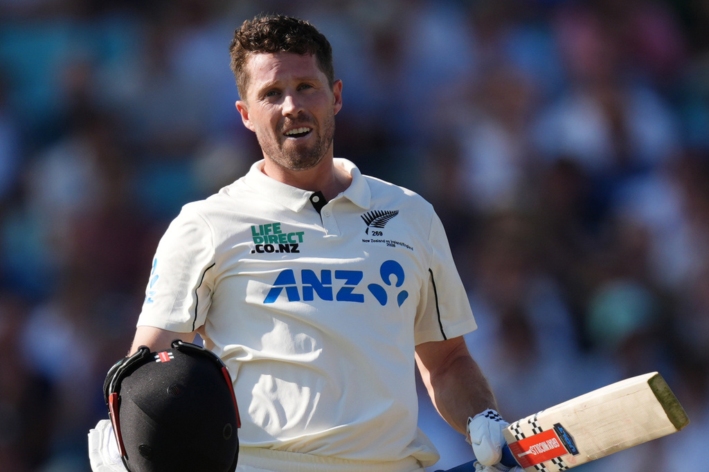 New Zealand's Henry Nicholls celebrates reaching his century on day three of the second cricket test between England and New Zealand, in London, Friday June 19, 2026. (Ben Whitley/PA via AP)