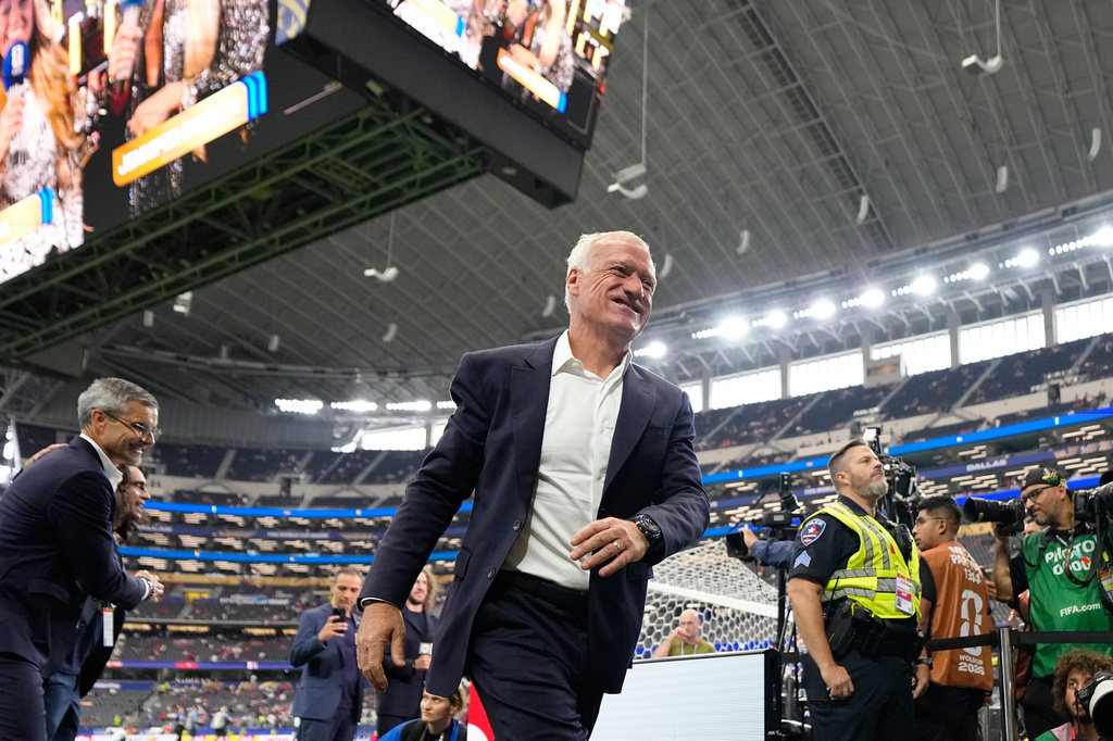 France head coach Didier Deschamps smiles on to the pitch before the World Cup semifinal soccer match between France and Spain in Arlington, Texas, near Dallas, Tuesday, July 14, 2026. (AP Photo/Ashley Landis)