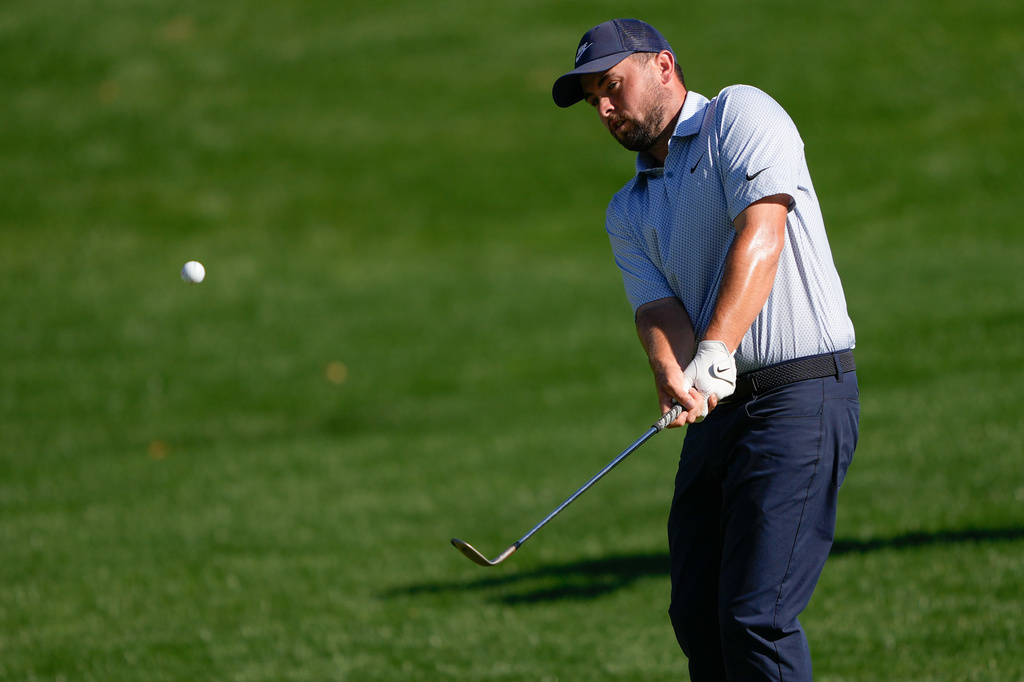 Alex Fitzpatrick, of England, chips on the 15th hole during the final round of the Truist Championship golf tournament at the Quail Hollow Club, Sunday, May 10, 2026, in Charlotte, N.C. (AP Photo/Chris Carlson)