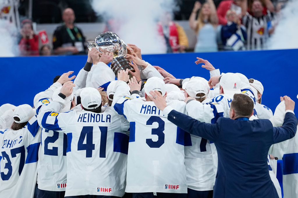 Finland players celebrate with trophy after winning the 2026 IIHF Men's Ice Hockey World Championship final match against Switzerland, in Zurich, Switzerland, Sunday, May 31, 2026. (AP Photo/Darko Bandic)