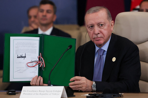 Turkey's President Recep Tayyip Erdogan holds a signed document during a summit to support ending the more than two-year Israel-Hamas war in Gaza after a breakthrough ceasefire deal, Monday, Oct. 13, 2025, in Sharm El Sheikh, Egypt. (Suzanne Plunkett/Pool via AP) Turkey's President Recep Tayyip Erdogan holds a signed document during a summit to support ending the more than two-year Israel-Hamas war in Gaza after a breakthrough ceasefire deal, Monday, Oct. 13, 2025, in Sharm El Sheikh, Egypt. (Suzanne Plunkett/Pool via AP)