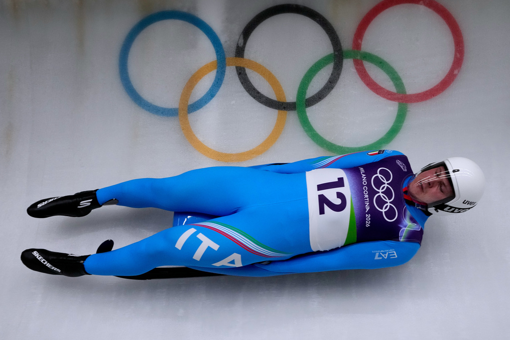 Italy's Dominik Fischnaller slides down the track during a men's single luge run at the 2026 Winter Olympics, in Cortina d'Ampezzo, Italy, Saturday, Feb. 7, 2026. (AP Photo/Aijaz Rahi)