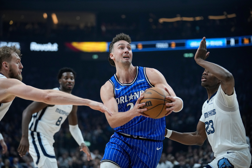 Orlando Magic forward Franz Wagner (22) controls the ball during an NBA basketball game between Orlando Magic and Memphis Grizzlies in Berlin, Germany, Thursday, Jan. 15, 2026. (AP Photo/Ebrahim Noroozi)