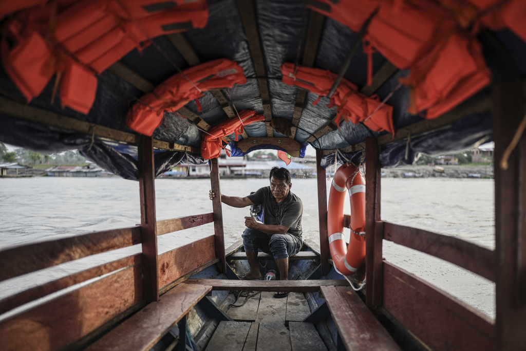 A boat captain prepares to pick up passengers on the Amazon River in Santa Rosa, Peru, an island at the border with Colombia and Brazil, Saturday, Aug. 16, 2025. (AP Photo/Ivan Valencia)
