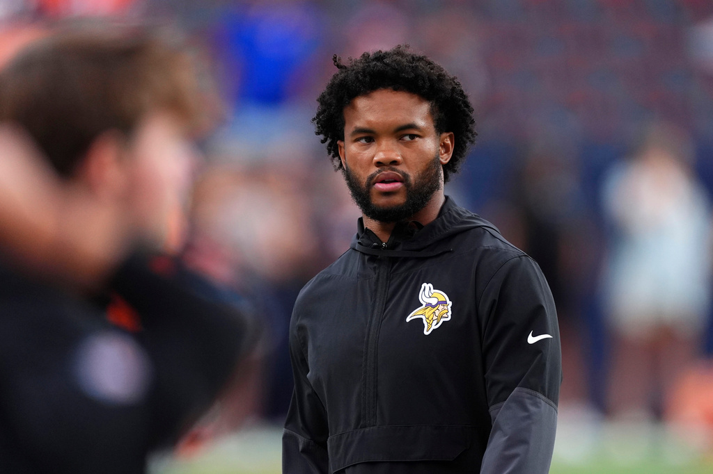 Minnesota Vikings quarterback Kyler Murray walks on the field before a preseason NFL football game against the Denver Broncos, Friday, Aug. 28, 2026, in Denver. (AP Photo/David Zalubowski)