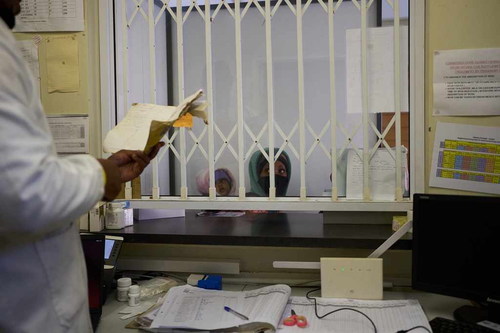 FILE - A woman waits for medication inside a pharmacy in a clinic in Ha Lejone, Lesotho, July 16, 2025. (AP Photo/Bram Janssen, File)