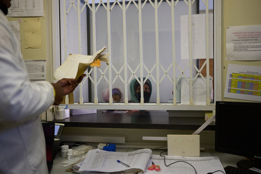 FILE - A woman waits for medication inside a pharmacy in a clinic in Ha Lejone, Lesotho, July 16, 2025. (AP Photo/Bram Janssen, File) FILE - A woman waits for medication inside a pharmacy in a clinic in Ha Lejone, Lesotho, July 16, 2025. (AP Photo/Bram Janssen, File)