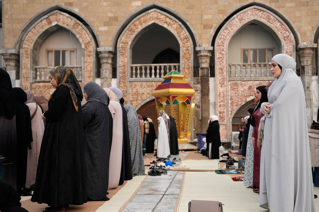 Muslims offer Eid al-Fitr prayers at the Abdul-Qadir al-Gailani mosque in Baghdad, Iraq, Friday, March 20, 2026. (AP Photo/Hadi Mizban)
