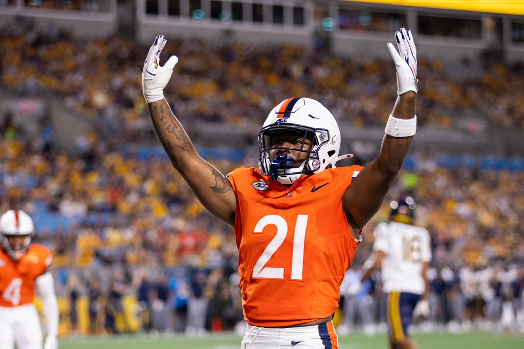 Virginia running back Jekail Middlebrook (21) celebrates after a touchdown in the first half of an NCAA college football game against West Virginia, Saturday, Sept. 19, 2026, in Charlotte, N.C. (AP Photo/Scott Kinser)