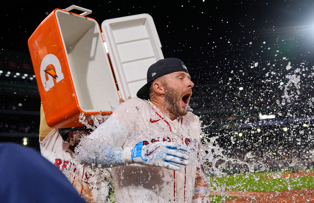 Boston Red Sox's Trevor Story is doused with a cooler of ice water after his game-winning, RBI single in the bottom 10th inning of a baseball game against the Seattle Mariners, Monday, Aug. 31, 2026, in Boston. (AP Photo/Charles Krupa) CORRECTION: The inning was corrected to 10th, instead of the ninth.